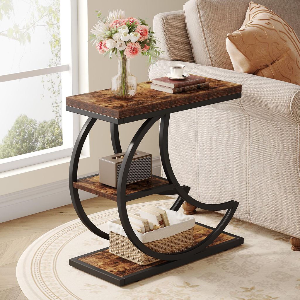 A side table with a wooden top and black metal frame, placed next to a sofa in a living room.
