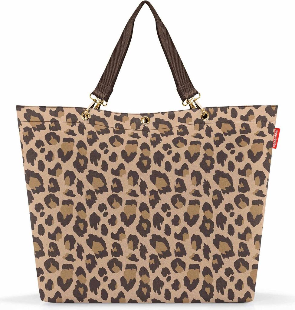 A leopard print shopper bag with brown handles against a white background.