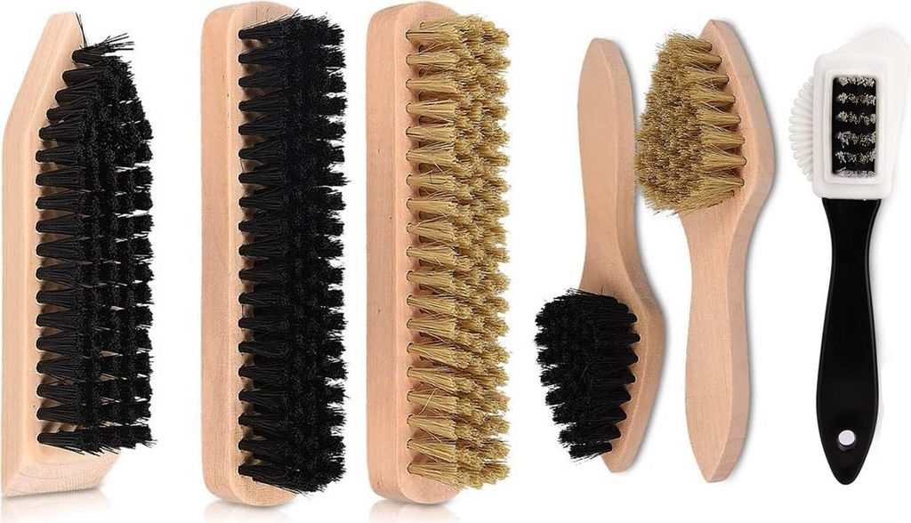 A collection of shoe cleaning brushes and a polishing cloth arranged on a white background.