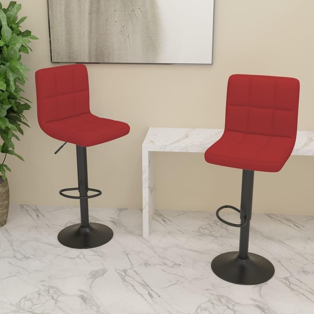 Two red bar stools are shown in a room with a marble floor and a white console table.