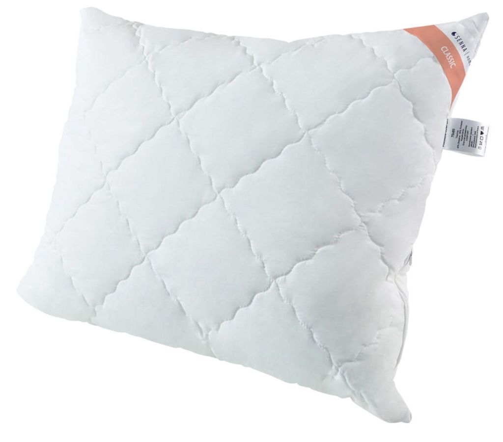 A white quilted pillow on a white background.