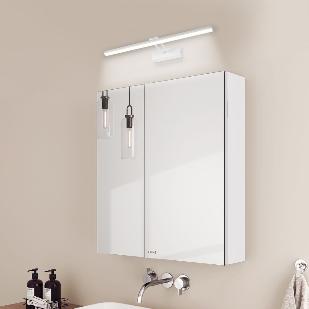 A modern bathroom vanity with a mirrored cabinet and wall-mounted light fixtures.