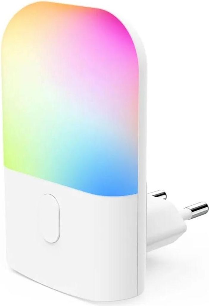 A white LED night light with a multicolored light display, plugged into a wall socket.
