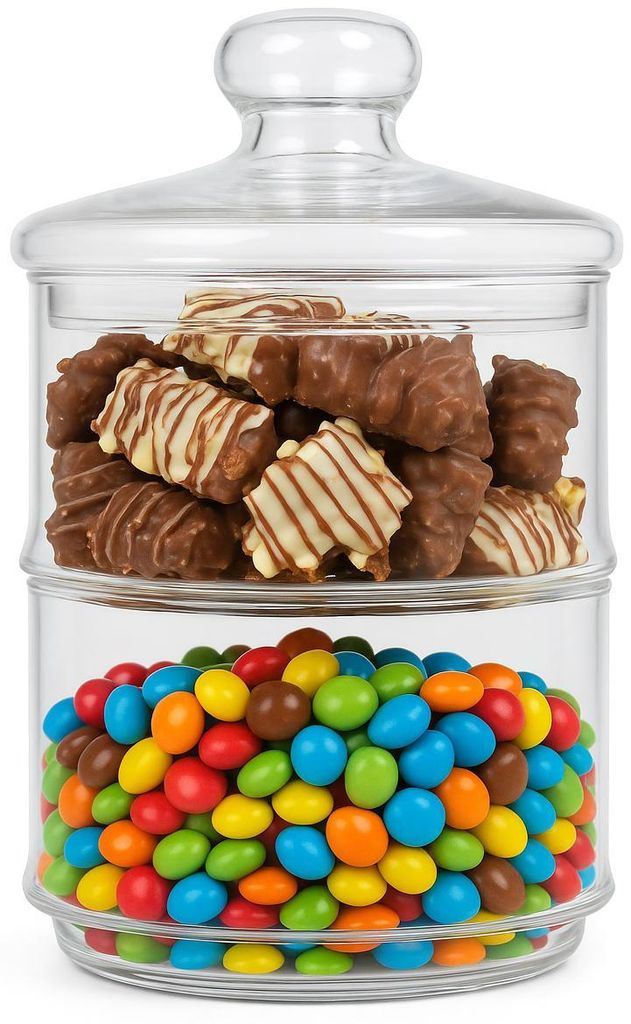 A two-tiered glass candy jar filled with chocolates and colorful candies.