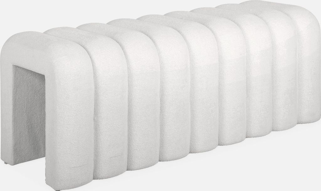 A white upholstered bench with a ribbed design.