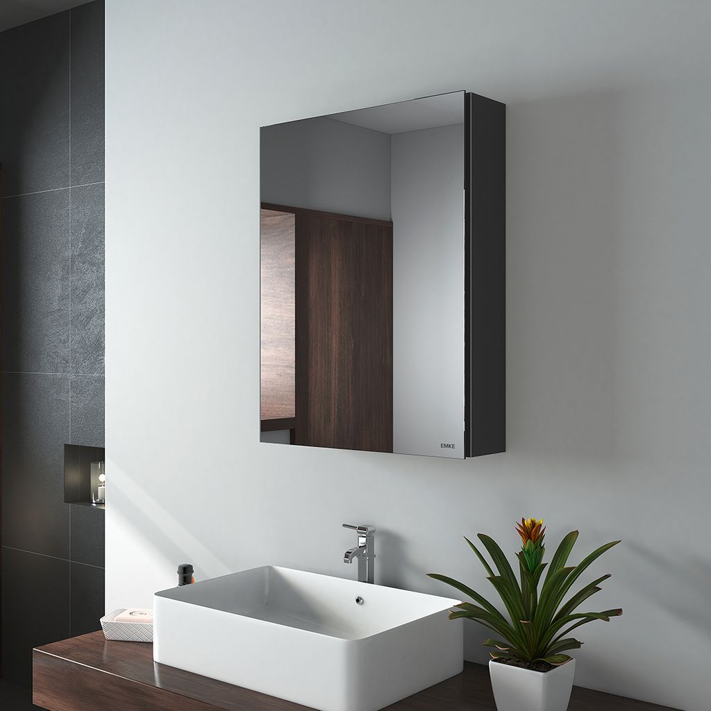 A modern bathroom with a sink, faucet, and a medicine cabinet with a mirror.