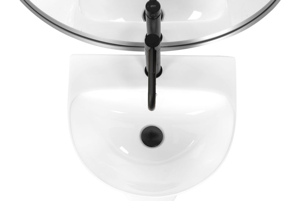 A top-down view of a white sink with a black faucet.