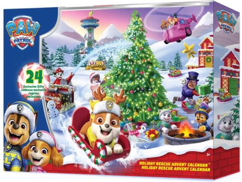A festive winter scene with Paw Patrol characters and a Christmas tree, presented on the packaging of an advent calendar.
