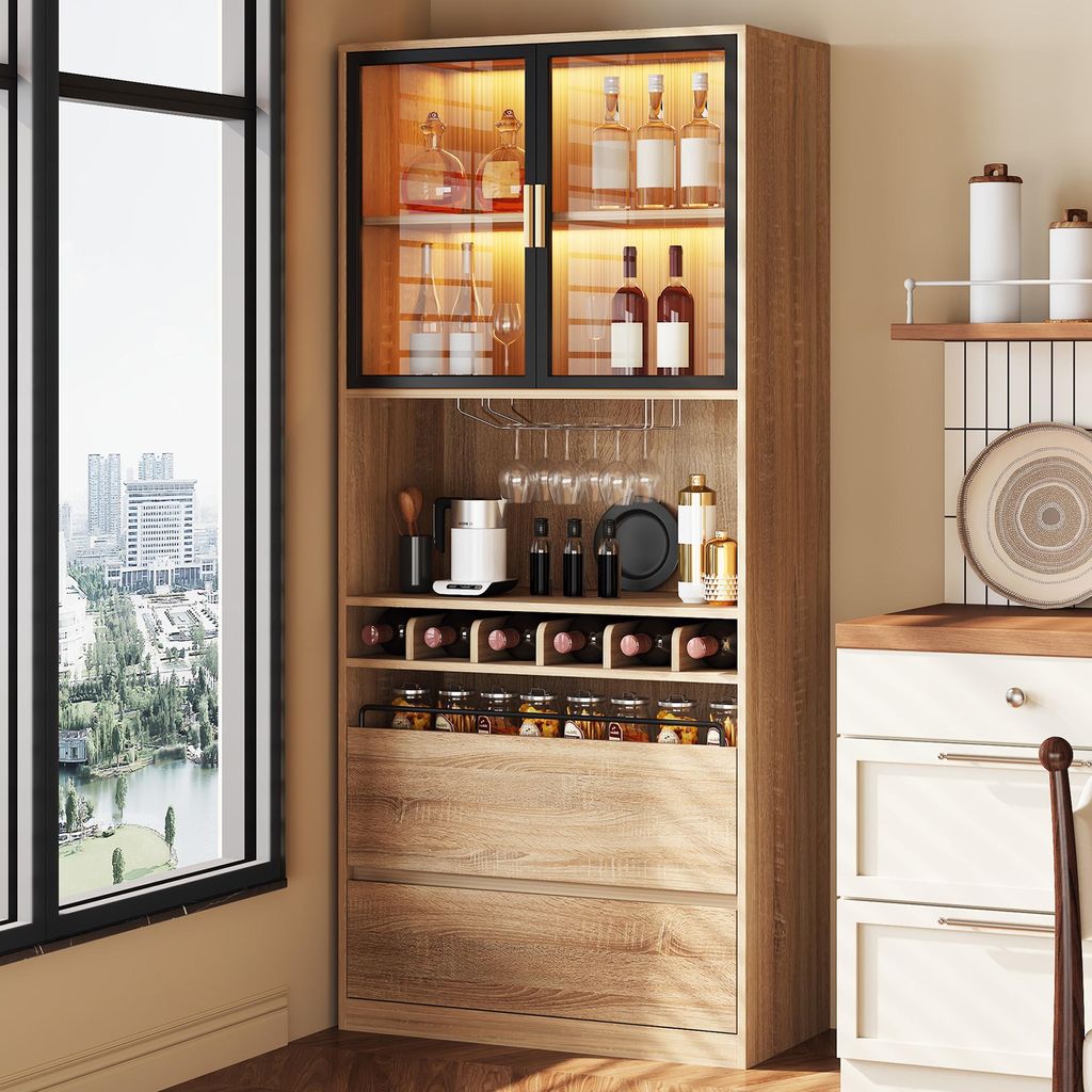 A tall, narrow cabinet with glass doors and LED lighting, filled with bottles and jars, is shown next to a large window overlooking a city.