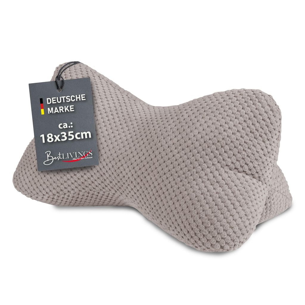 A taupe-colored bone-shaped pillow with a tag attached.