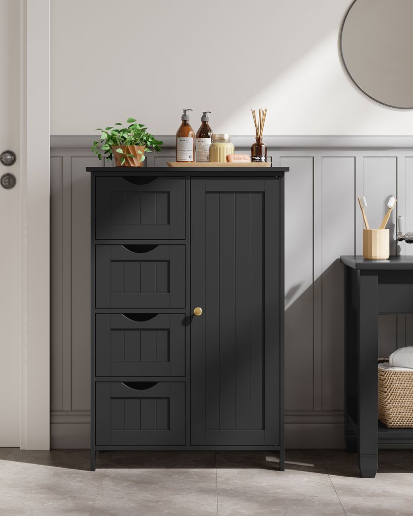 A dark gray bathroom cabinet with four drawers and a single door, placed in a bathroom setting with wainscoting and a mirror visible.