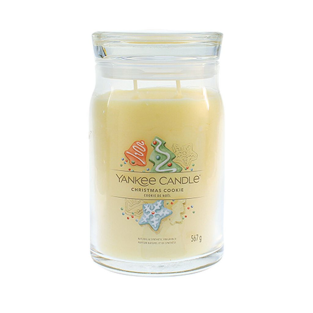 A Yankee Candle Christmas Cookie scented candle in a glass jar with a lid.