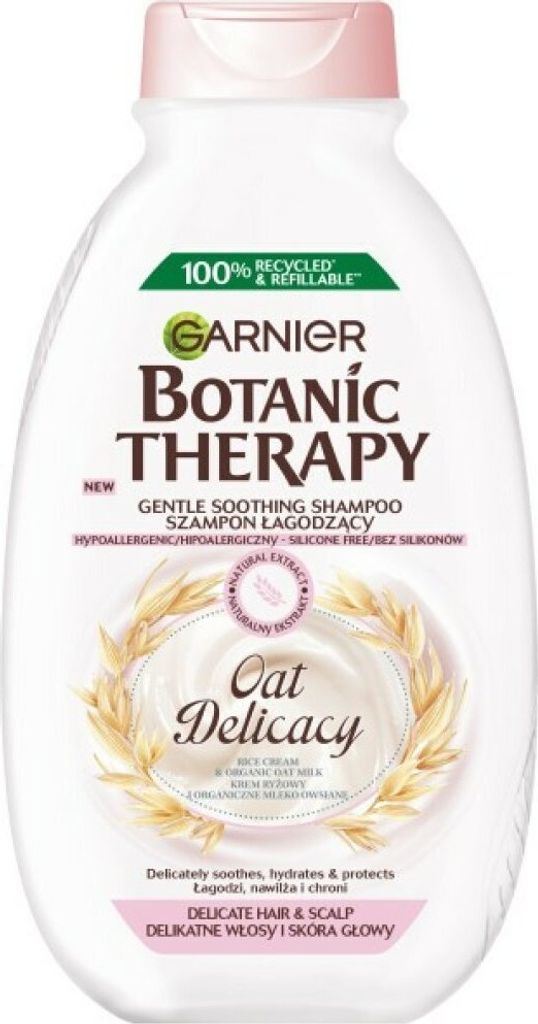 A white bottle of Garnier Botanic Therapy Oat Delicacy shampoo with pink accents and a graphic of wheat stalks.