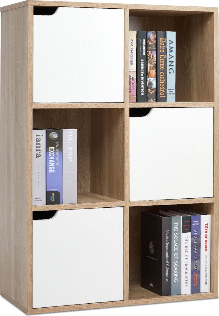 A bookshelf with books and white doors on some shelves.