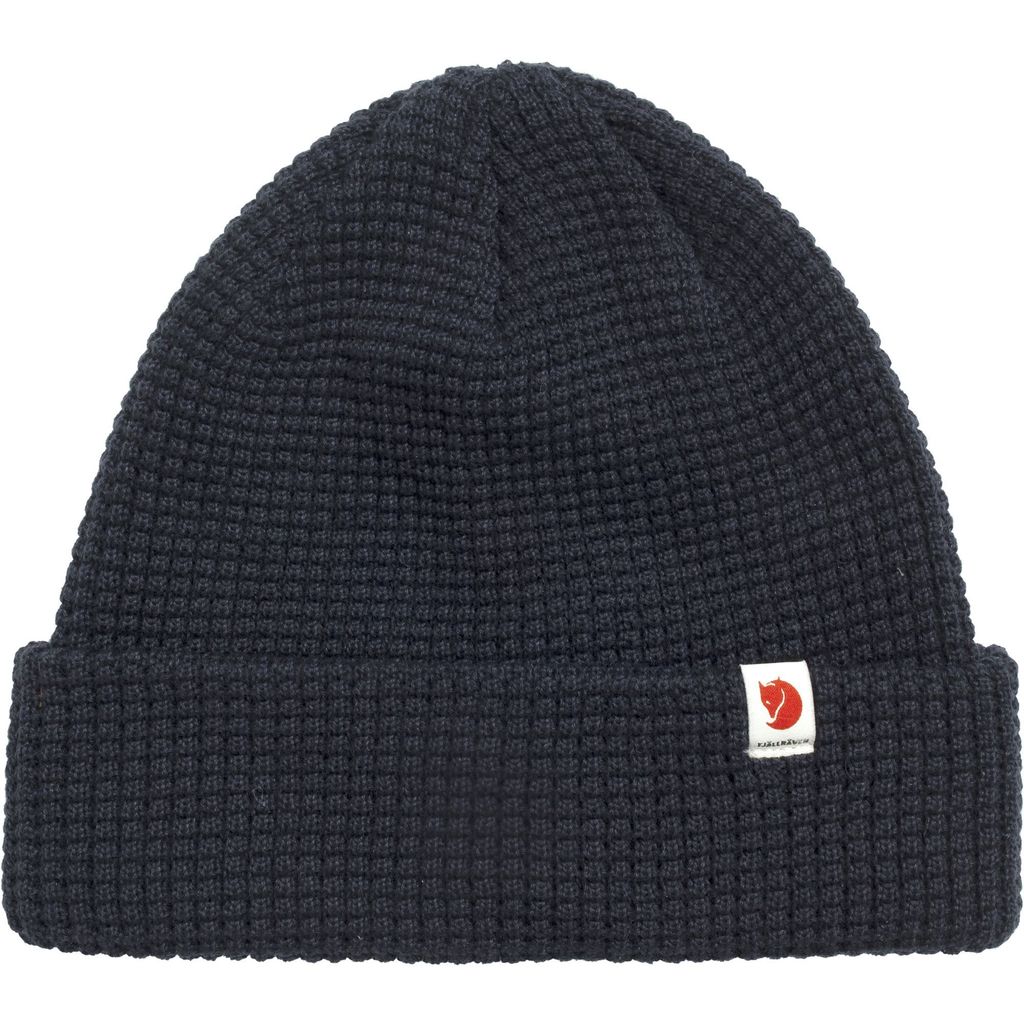 A dark navy knitted beanie with a small white logo patch on the front.