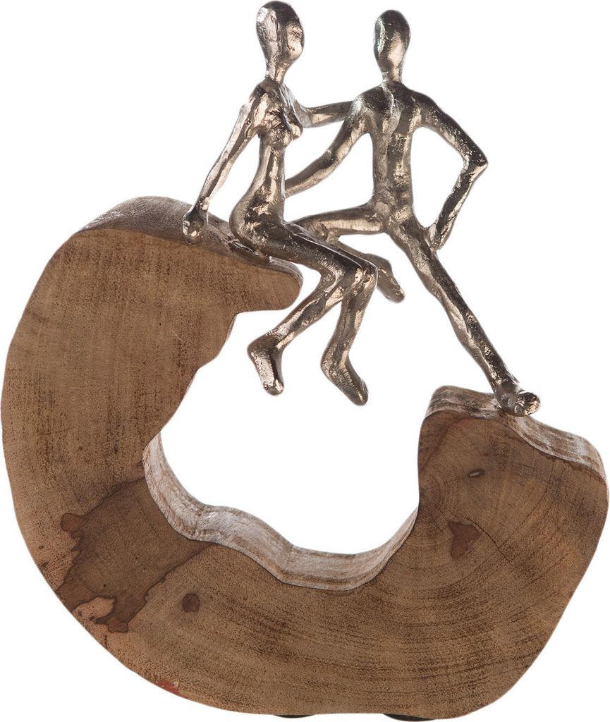 A decorative sculpture of two figures sitting on a wooden base.