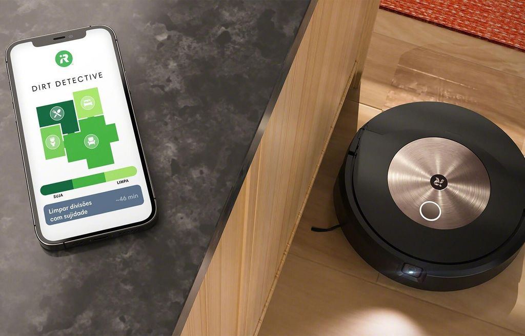 A robot vacuum cleaner is shown next to a smartphone displaying its app interface.