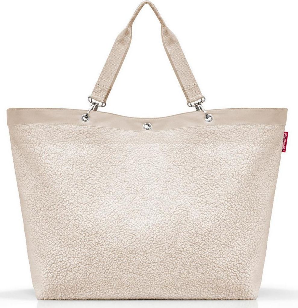 A beige tote bag with a textured, fluffy exterior and a smooth beige trim and handles.
