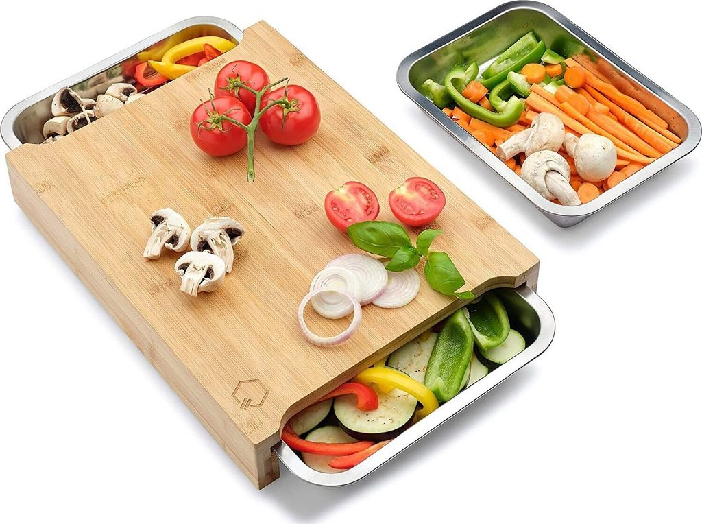 A bamboo cutting board with integrated stainless steel trays filled with various chopped vegetables and mushrooms.