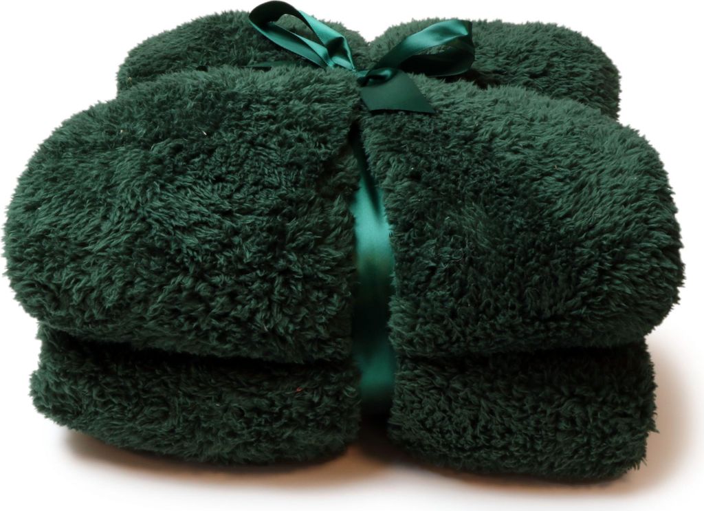 A folded dark green fluffy blanket tied with a green ribbon.