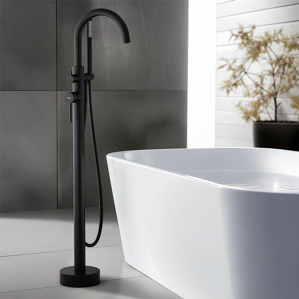 A modern bathroom with a freestanding bathtub and a black floor-mounted faucet.