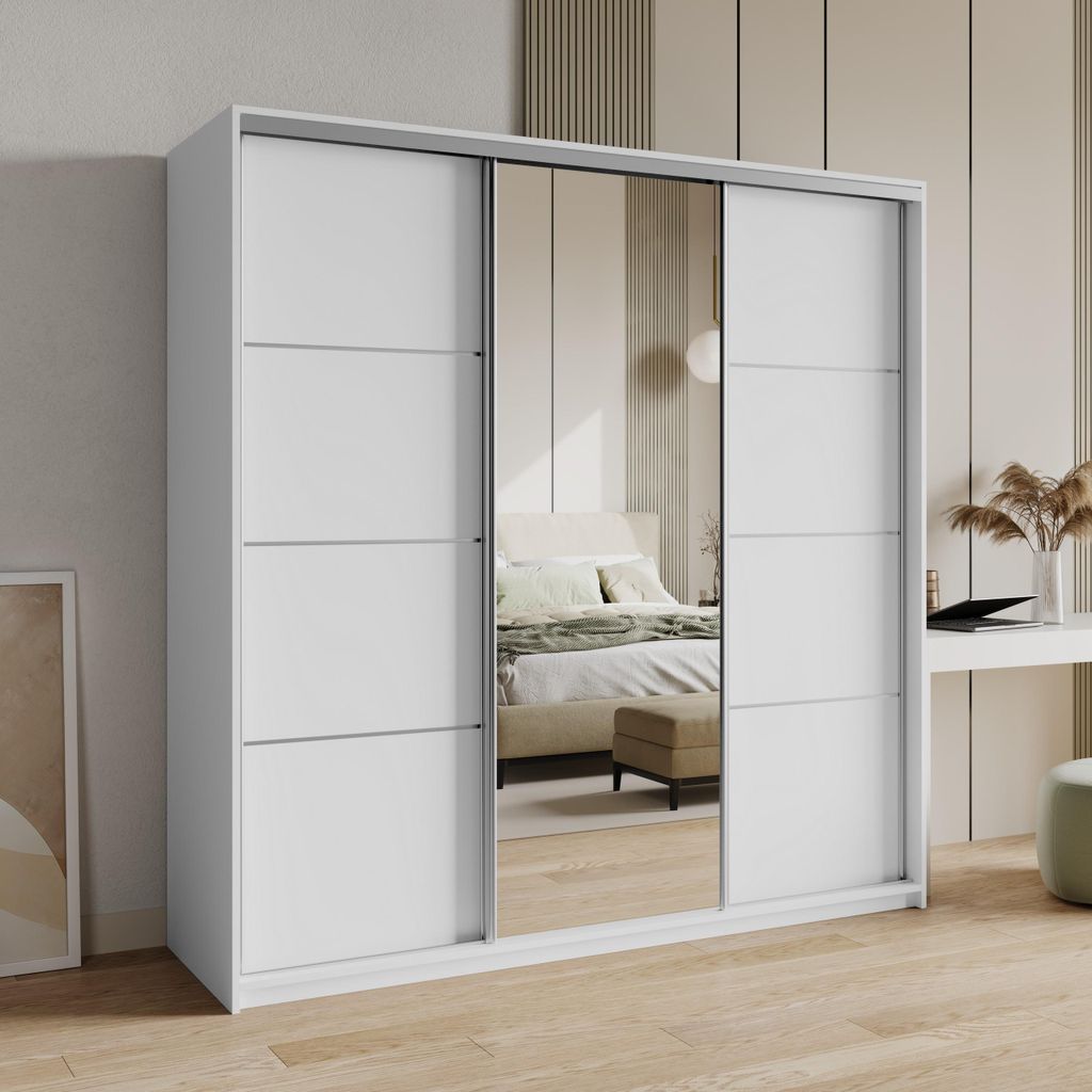 A white sliding door wardrobe with mirrored doors, reflecting a bedroom interior.
