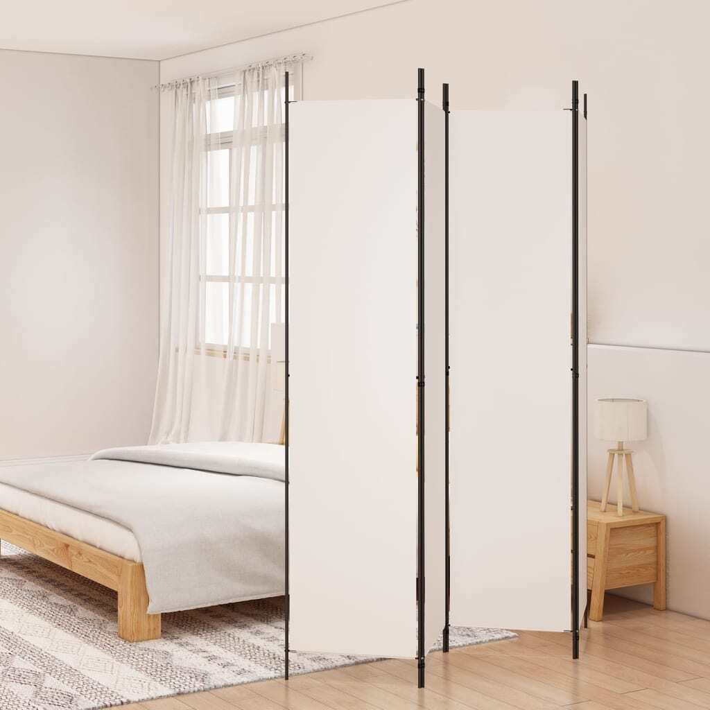 A white room divider is set up in a bedroom next to a bed and a nightstand with a lamp.