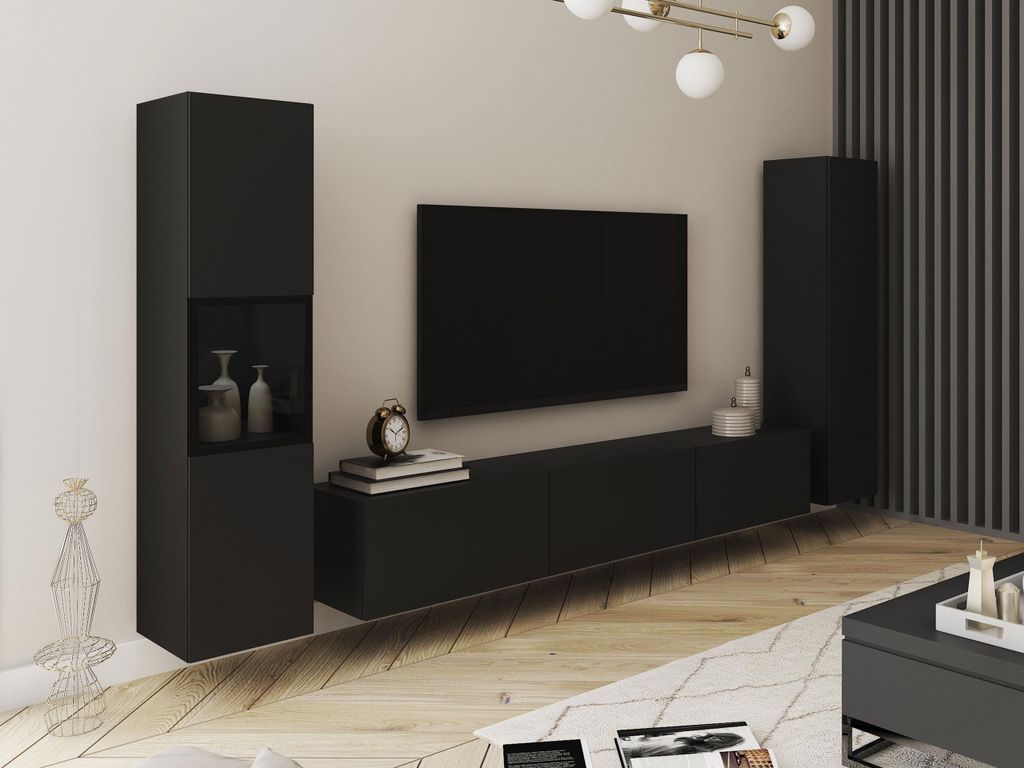 A modern living room setup with a black TV stand, a large black TV, and a tall black cabinet.