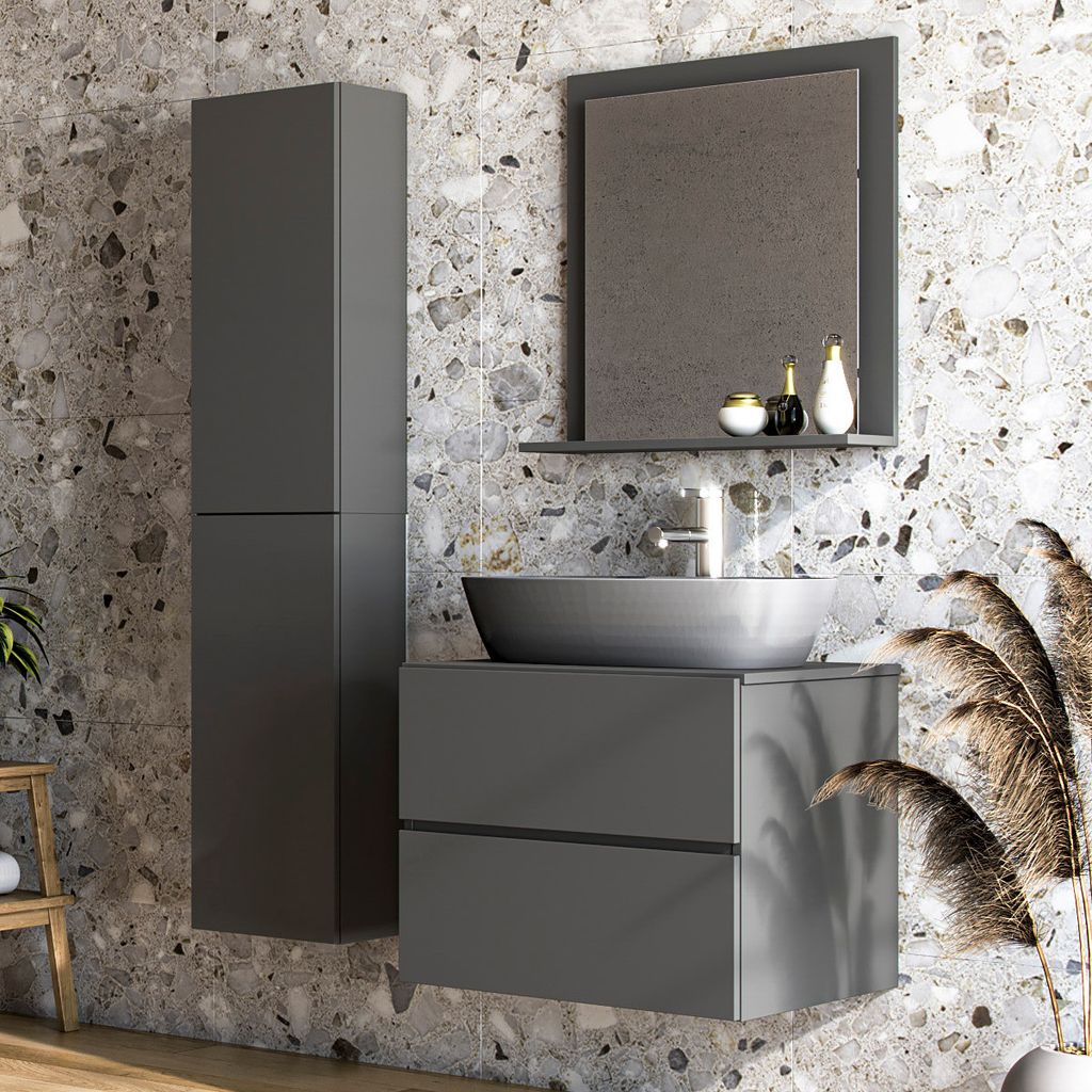 A modern bathroom vanity with a sink, mirror, and storage cabinet, set against a textured stone wall.