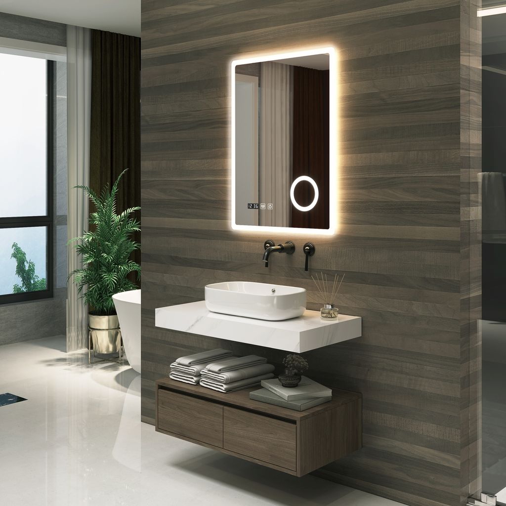 A modern bathroom with a vanity, sink, and illuminated mirror.