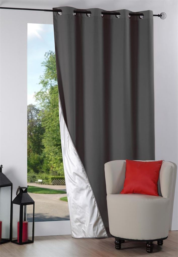 A curtain is partially drawn, revealing a view of a park and a chair with a pillow.