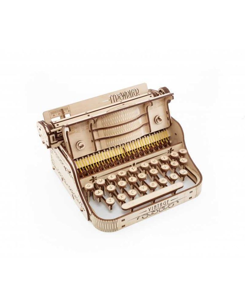 A wooden model of a typewriter is shown against a white background.