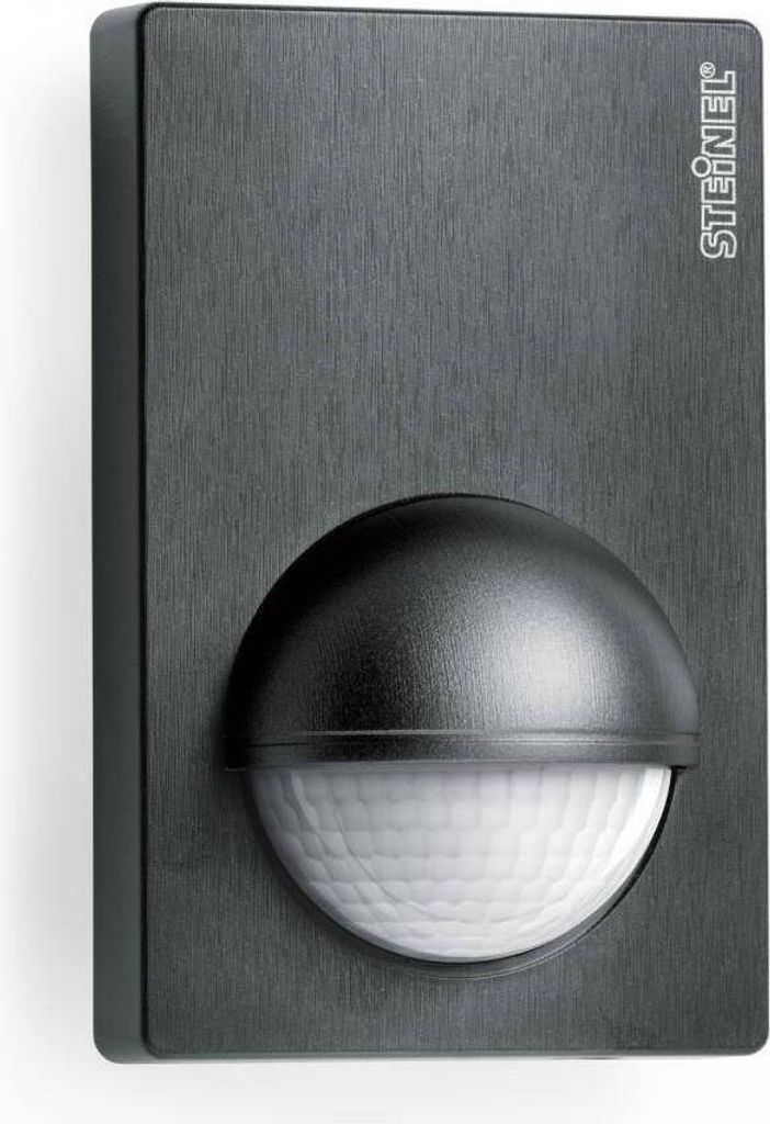 A black motion sensor with a textured surface and a domed sensor lens.