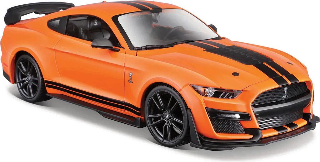 A bright orange toy model of a Ford Mustang Shelby GT500 with black racing stripes, shown from a three-quarter front angle against a white background.
