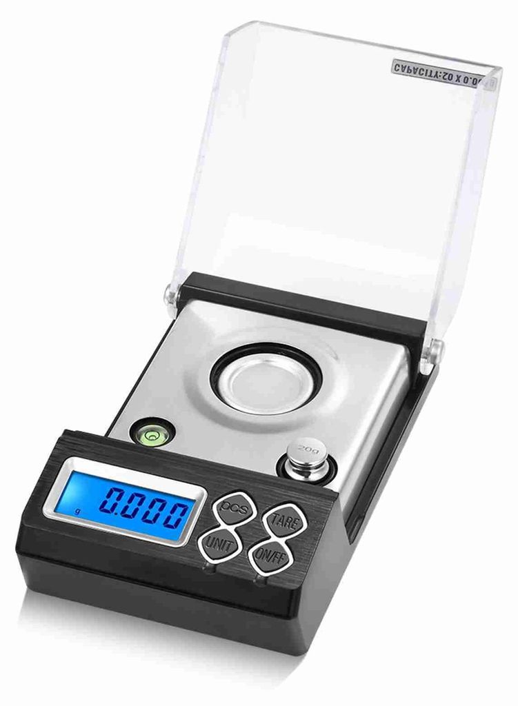A digital milligram scale with its protective cover open.