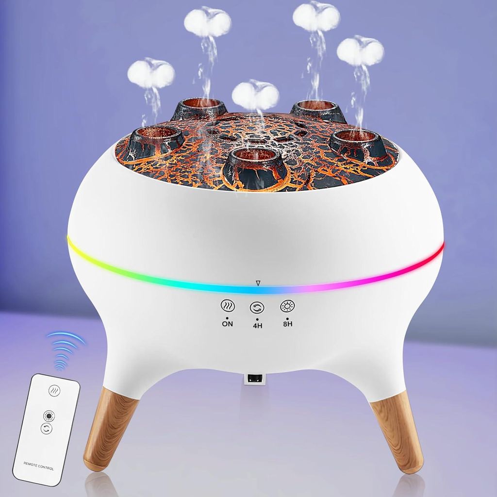 A white humidifier with a volcano-like top and wooden legs, emitting mist, with a remote control next to it.