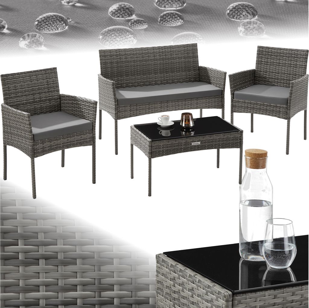 A rattan garden furniture set including a sofa, two chairs, and a coffee table, with water droplets on a textured background.