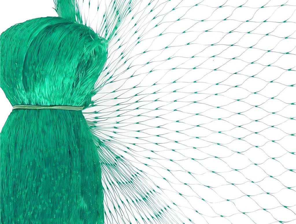 A close-up of a green bird net, bundled on the left and spread out on the right.