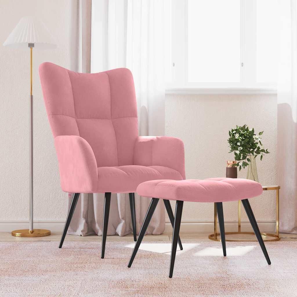 A pink velvet armchair and matching ottoman are placed in a room with a floor lamp and a small side table with a vase of flowers.