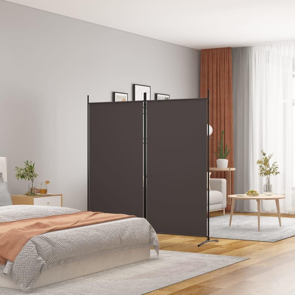 A bedroom with a bed, a nightstand, and a room divider.