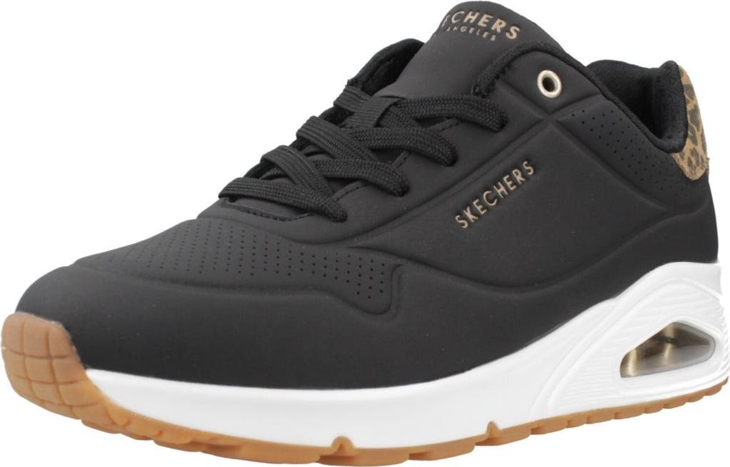 A side view of a black Skechers sneaker with a white sole and brown accents.