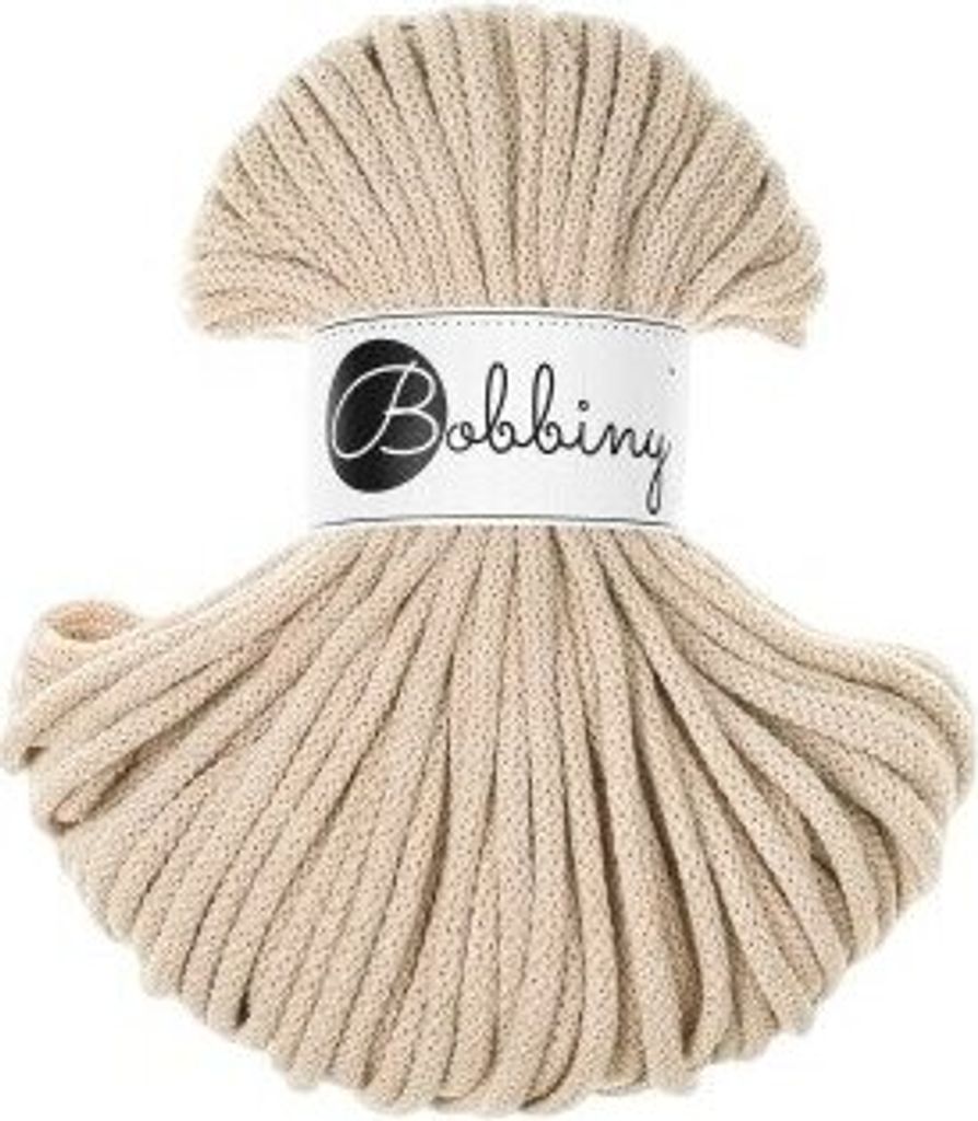 A spool of beige cord with a label.