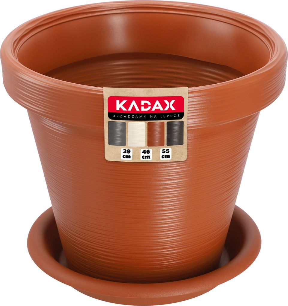 A terracotta-colored plastic plant pot with a matching saucer, shown against a white background. A label is attached to the front of the pot.