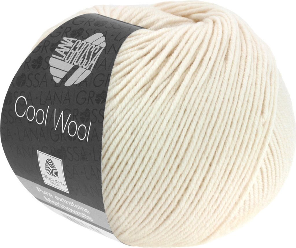 A ball of cream-colored wool yarn with a dark label wrapped around it.