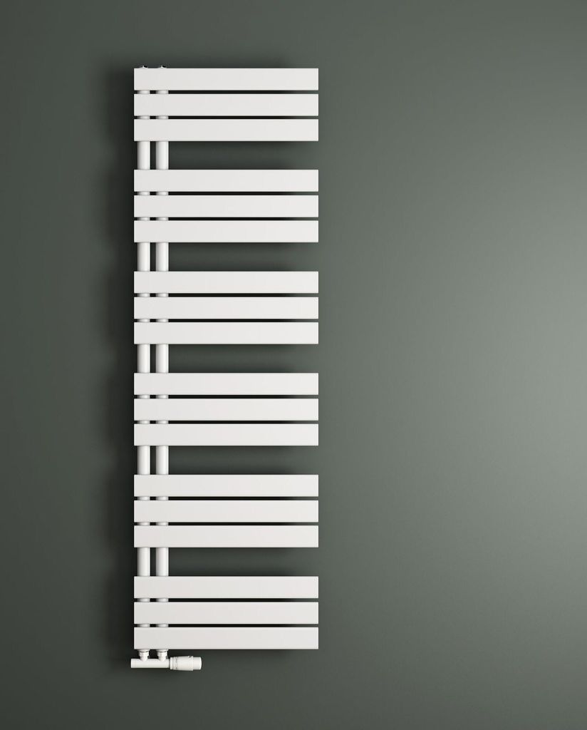 A white radiator is mounted on a gray wall.