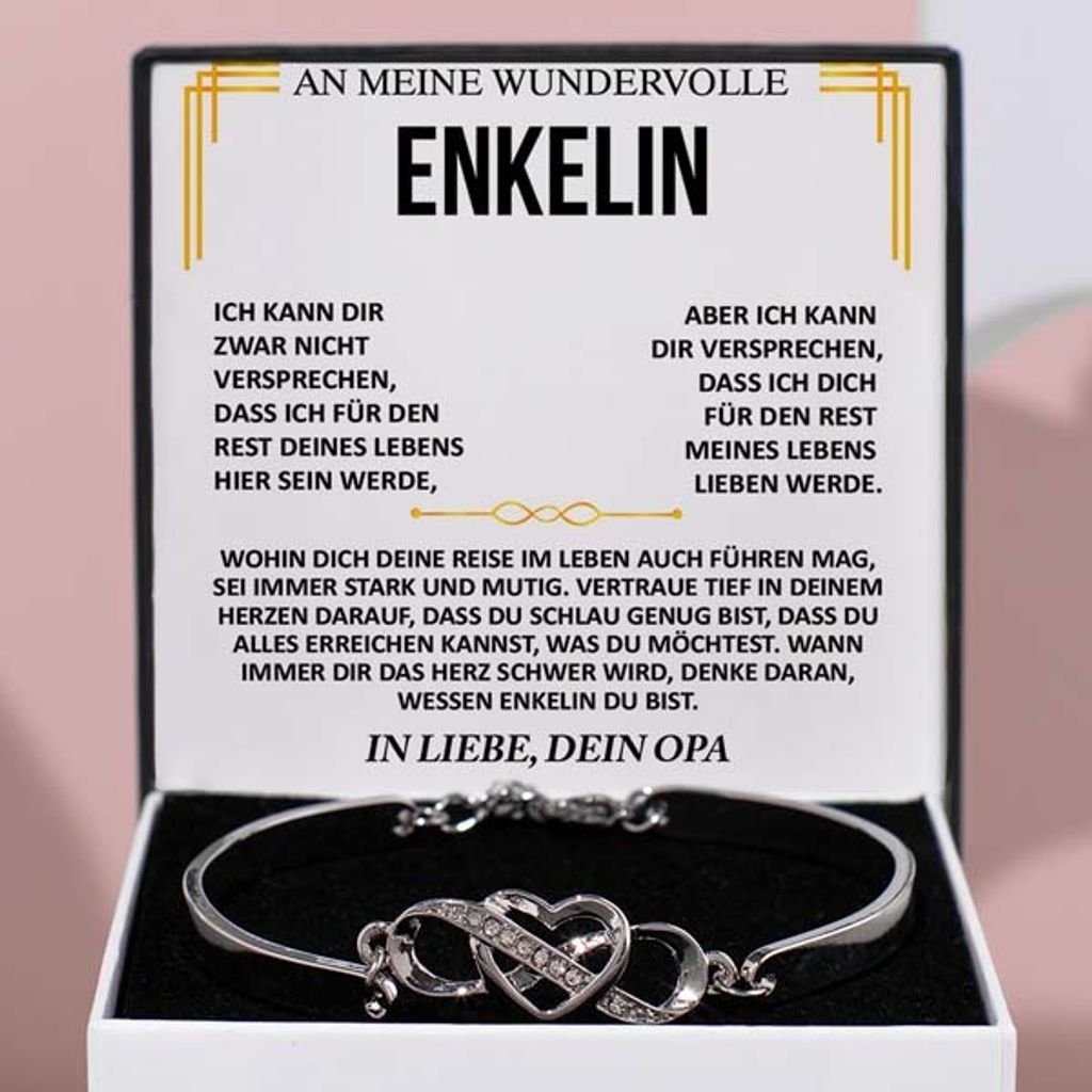 A jewelry box containing a bracelet, with a card inside displaying a message.