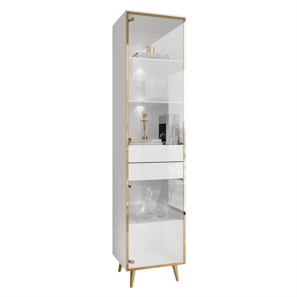 A tall, narrow white display cabinet with glass doors and gold accents, standing on angled gold legs.