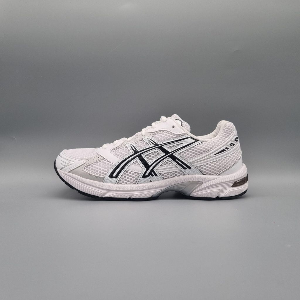 A side view of a single white Asics running shoe with black accents against a plain gray background.