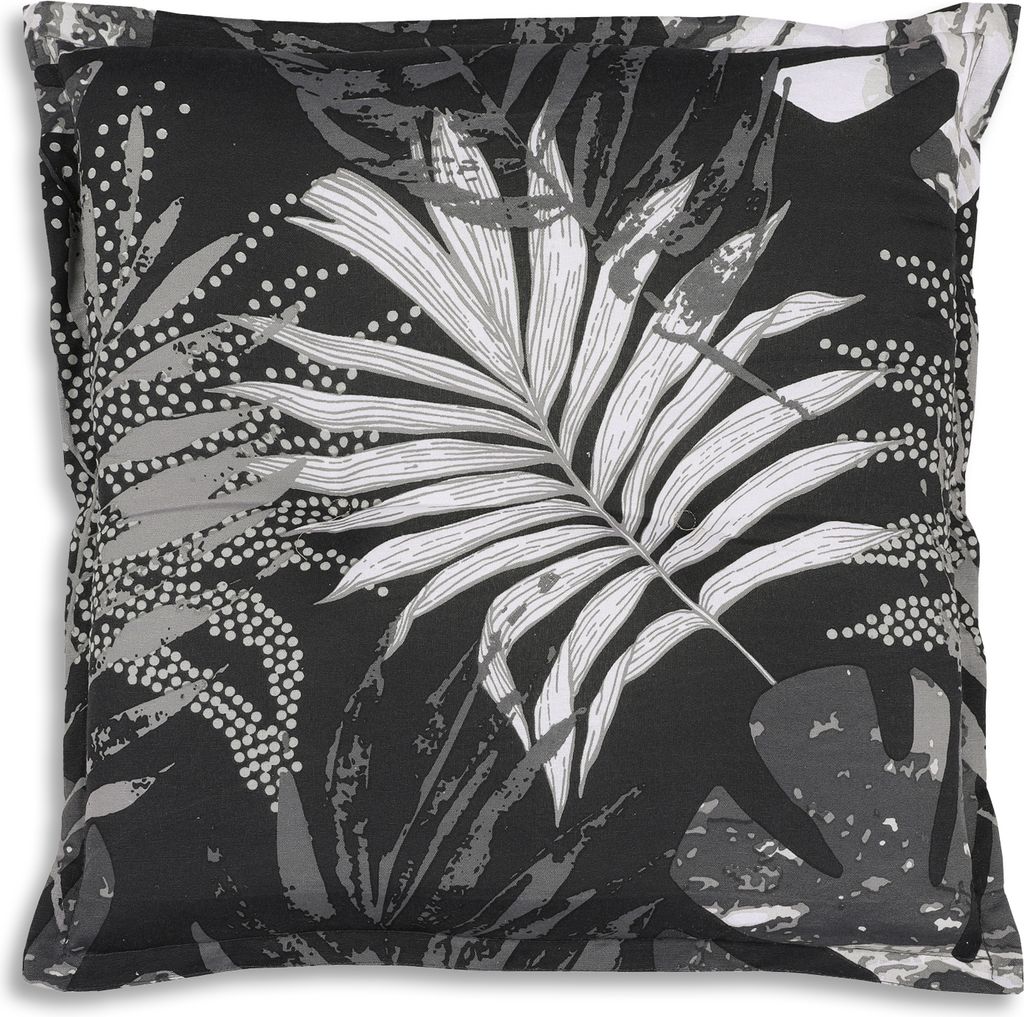A close-up view of a pillow with a tropical leaf pattern.