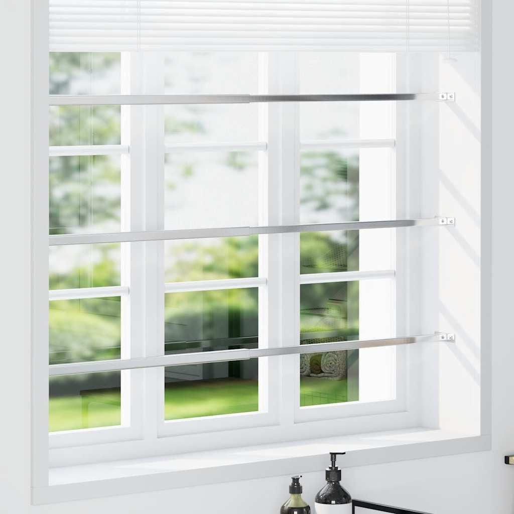 Three adjustable window security bars installed on a window.